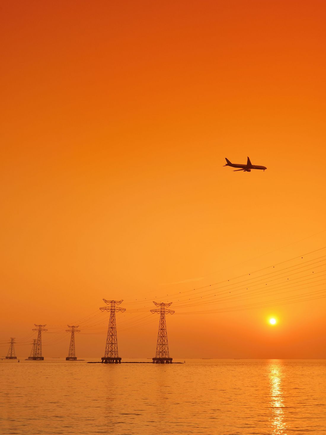 An airplane landing off over the sea